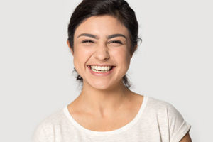 woman laughing with a big smile after getting dental fillings and sealants cinco ranch tx