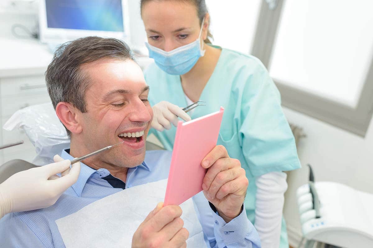 man looking at his One Day Dental Crowns