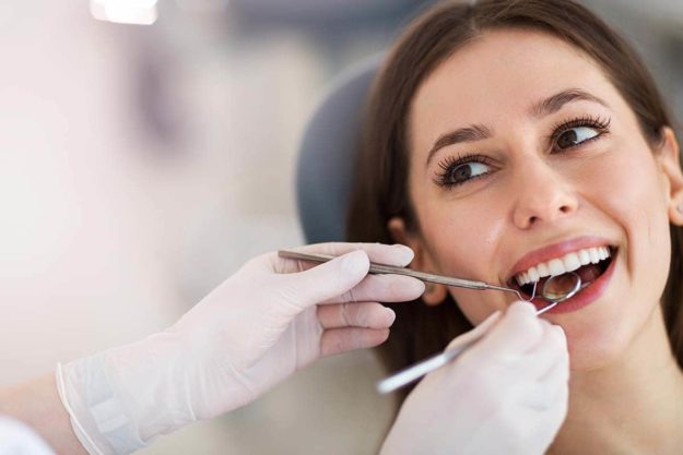 what is teeth whitening young woman receiving teeth whitening services