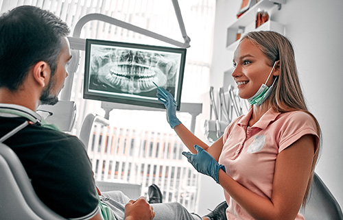 emergency dental services (2) dentist talking to her patient about emergency dental services