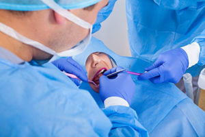 dentists performing oral surgery on a patient