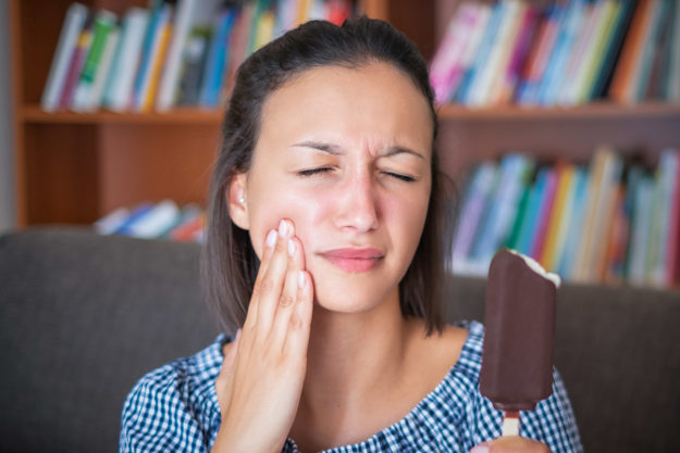 common dental problems (1) woman experiencing common dental problems