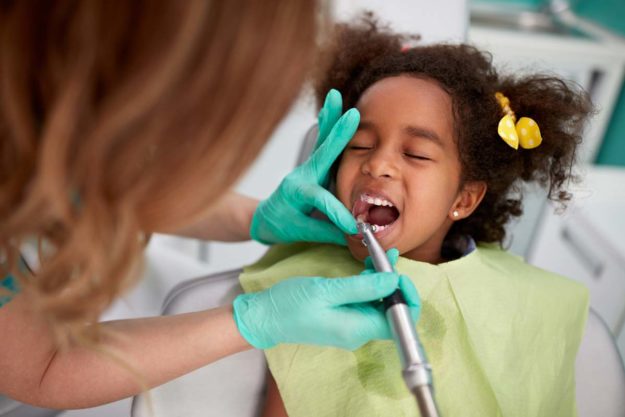 child getting pediatric dental emergency services