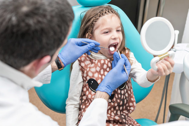 treating a chipped tooth (1) dentist treating a chipped tooth in a child