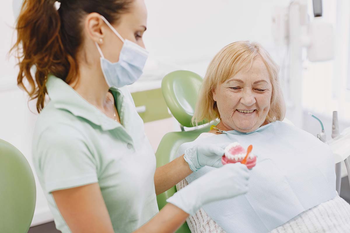 Types of Different Denture Implants patient getting dentures