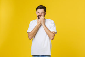 man who needs dental care for impacted teeth