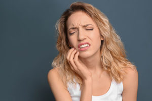 woman hurting from teeth grinding