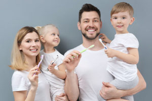 parents with children learning about family dentistry